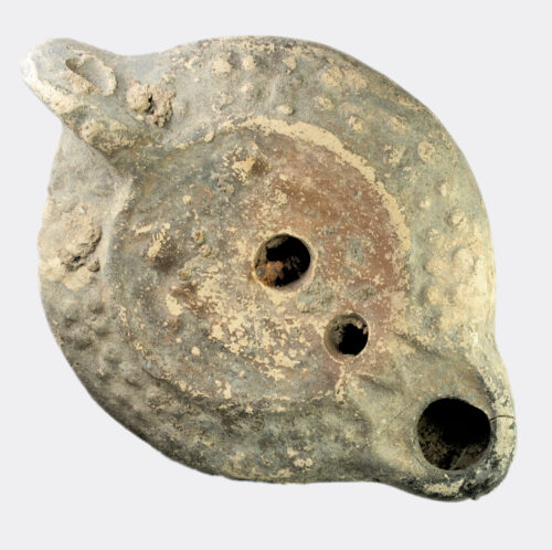 Roman pottery oil lamp with two figures