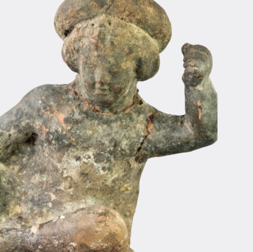 Greek Hellenistic terracotta figure of a seated youth