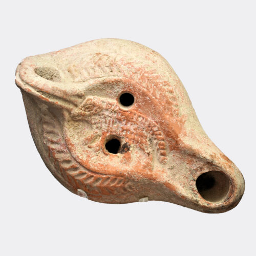 Roman pottery oil lamp with ram decoration